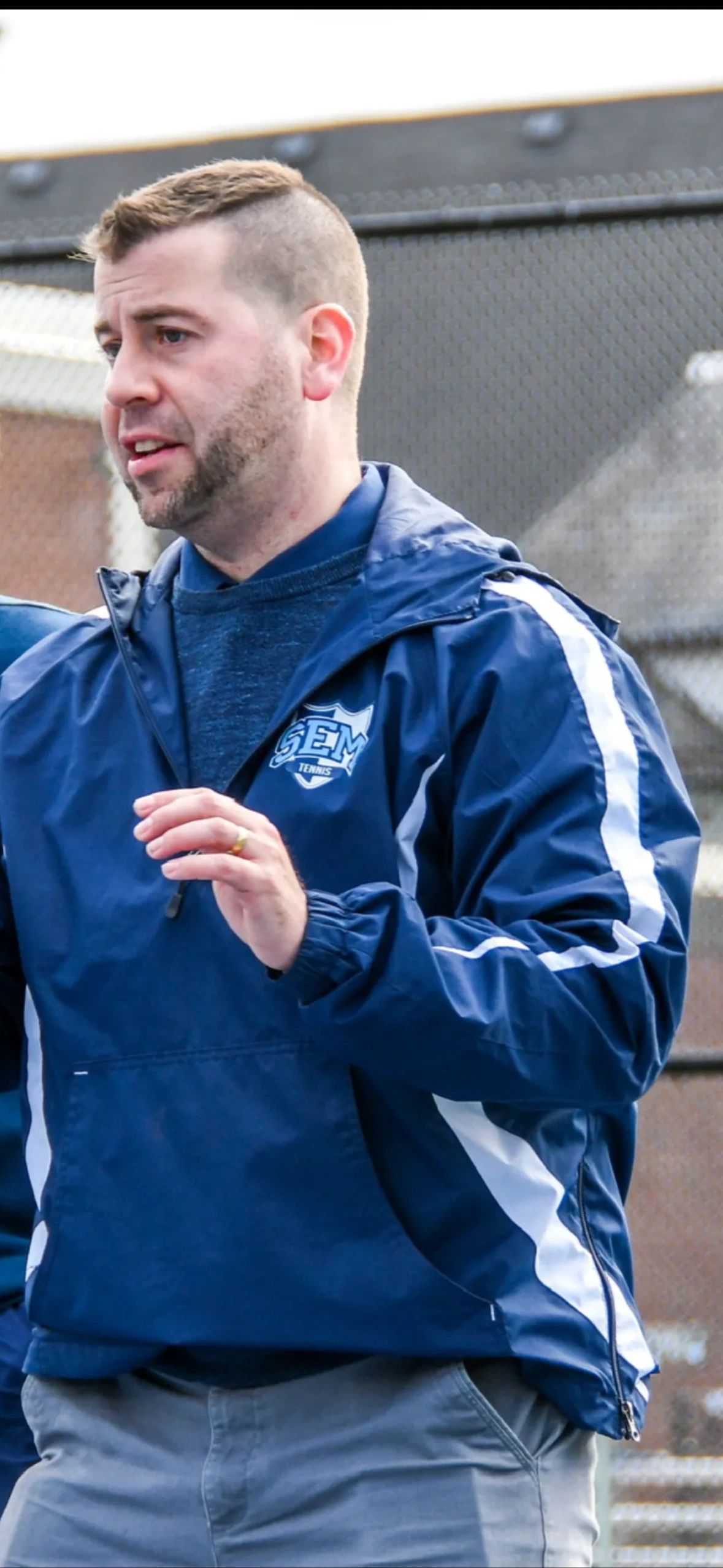 Tennis coach giving a private lesson to a young child